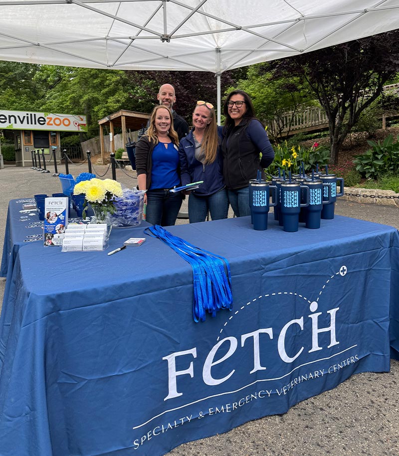 Four staff members posing behind table display at Greenville Zoo