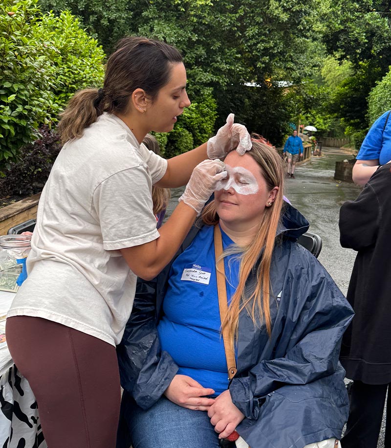 staff member getting face painted