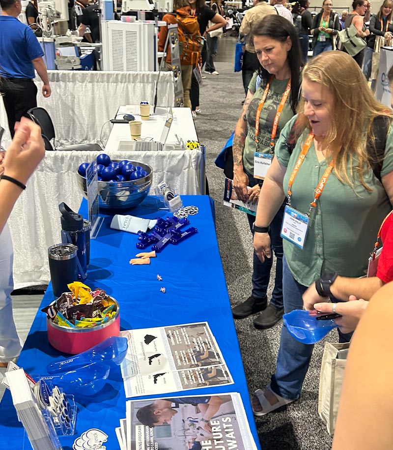 people attending IVECCS looking at Fetch Vets booth