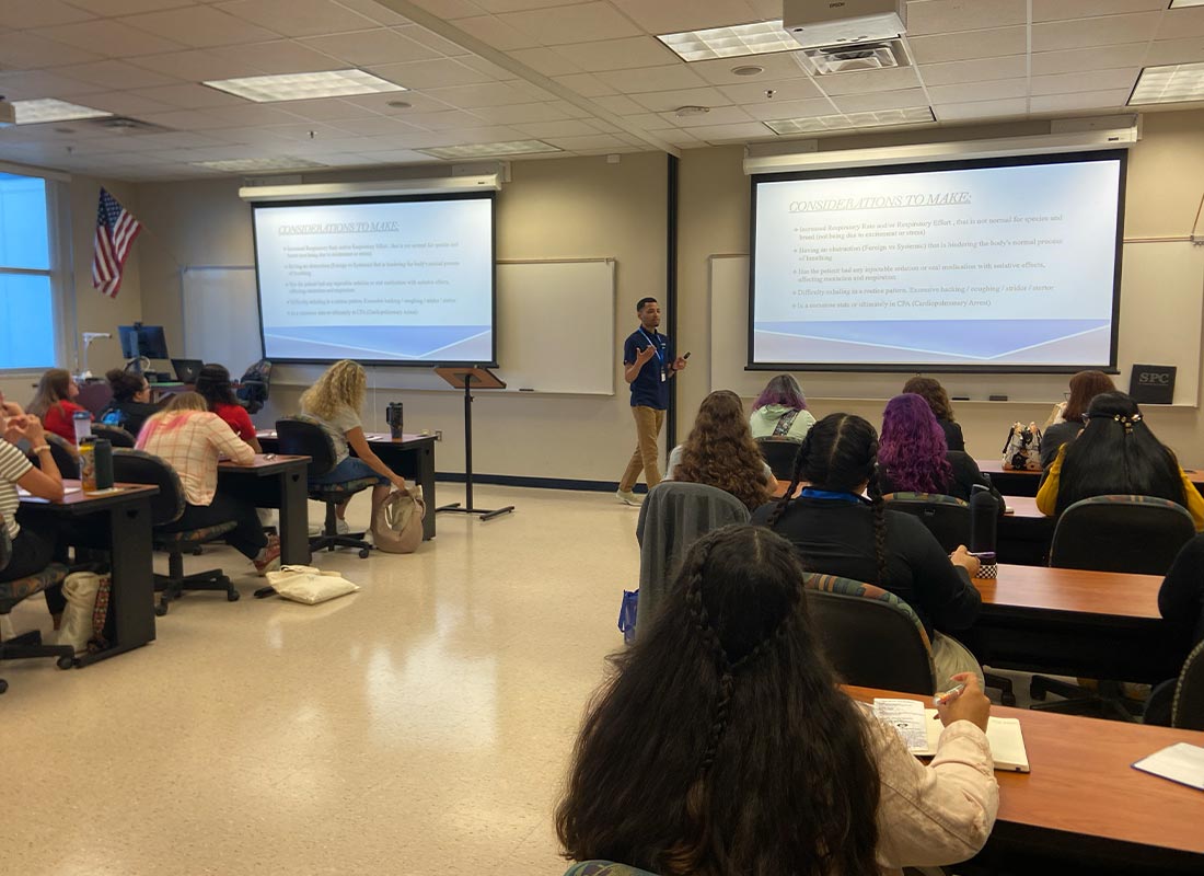 male staff member lecture classroom full of people with presentation at 2025 FVTA Technician Conference