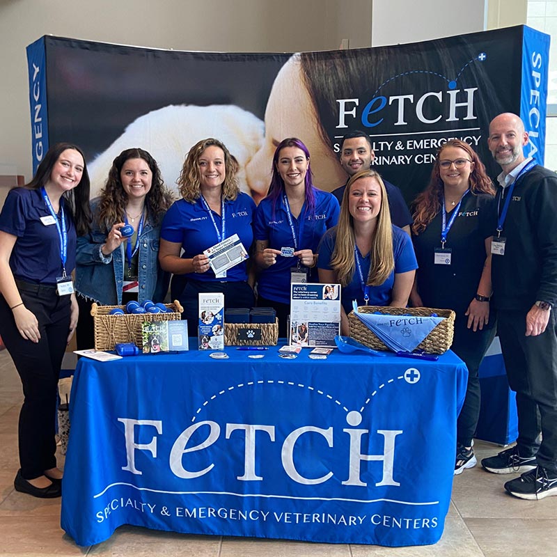 Fetch Vet staff members smiling and posing behind branded booth at 2025 FVTA Technician Conference
